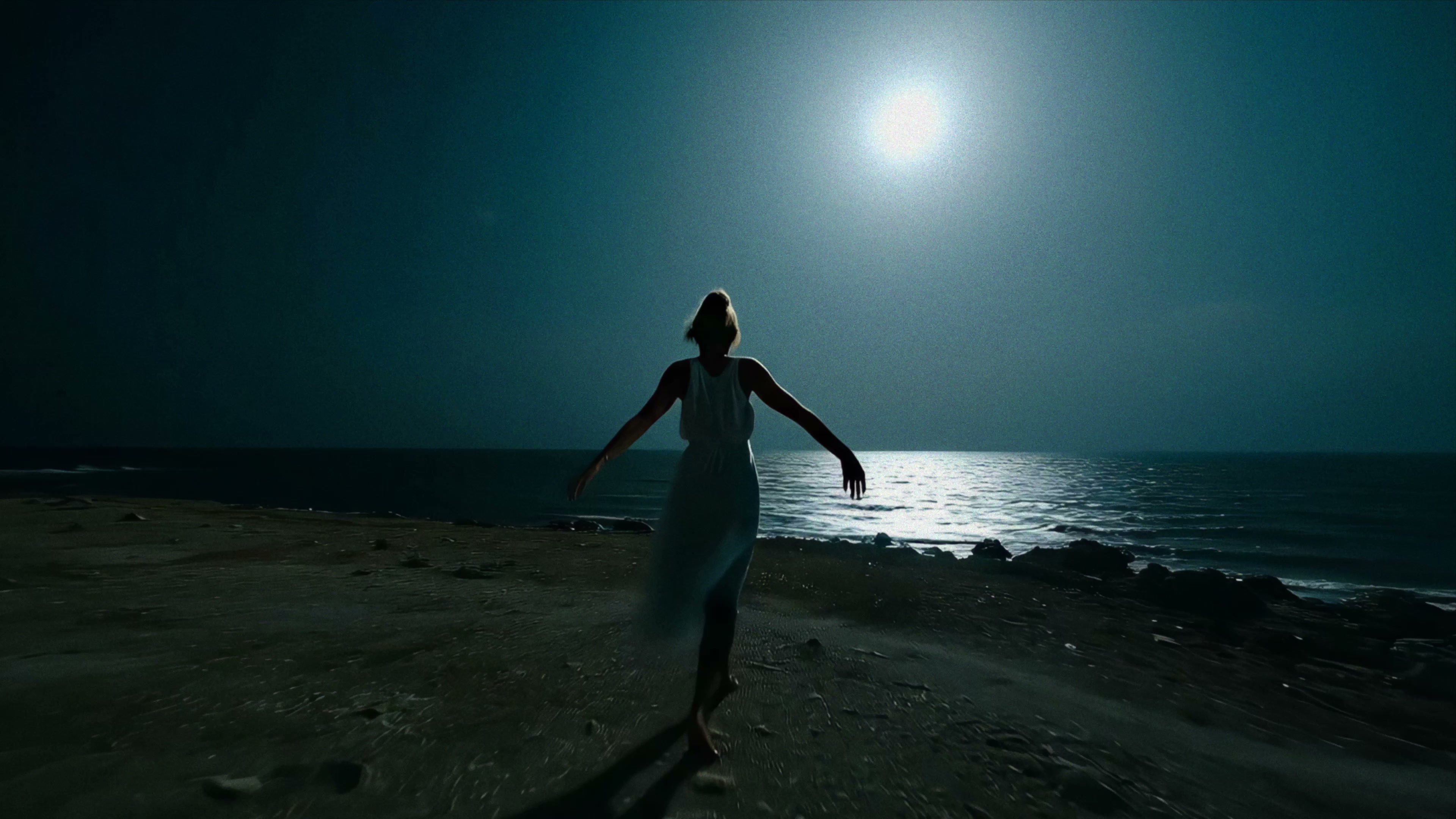 Alexandra Oz. in «Echoes» — dancing alone on a dark beach at night.