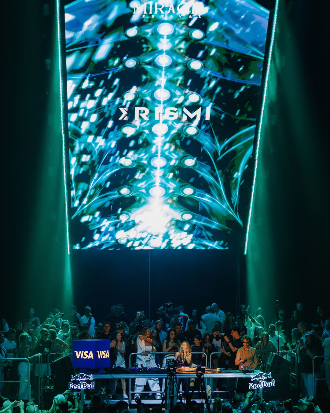 KRISMI logo inside the Neon Abyss world on the vertical LED screen