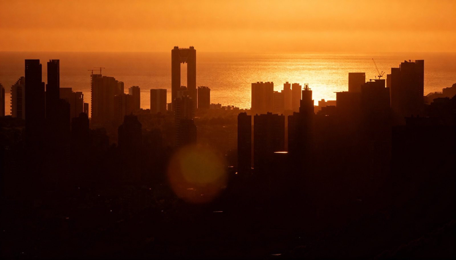 The city under a telephoto sun